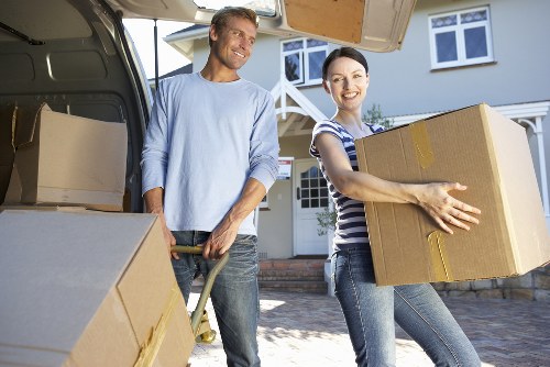 Careful wrapping of delicate household belongings before storage